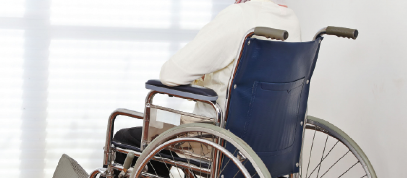 Senior Woman in wheel chair looking out window